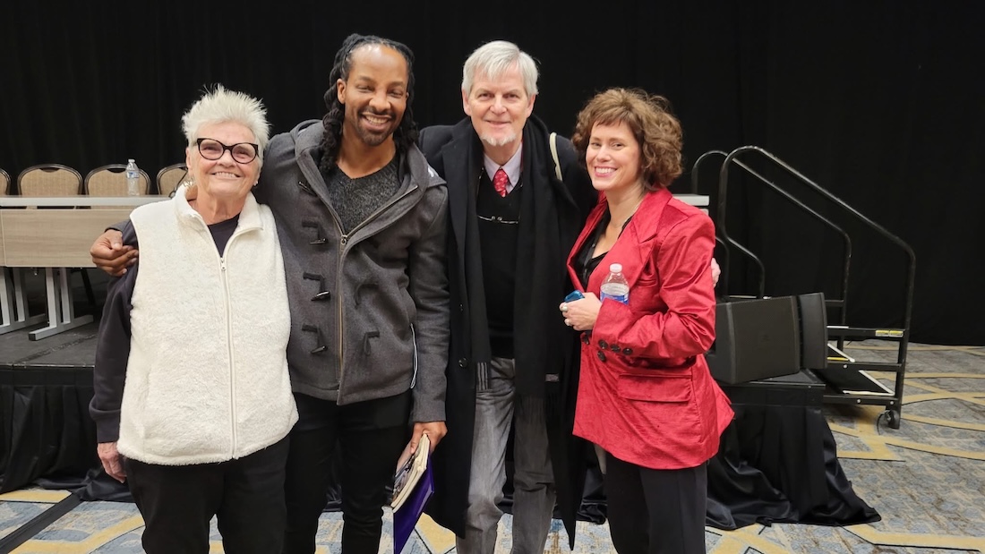 Kay Murphy, Jericho Brown, John Gery, and Carolyn Hembree smiling in front of stage